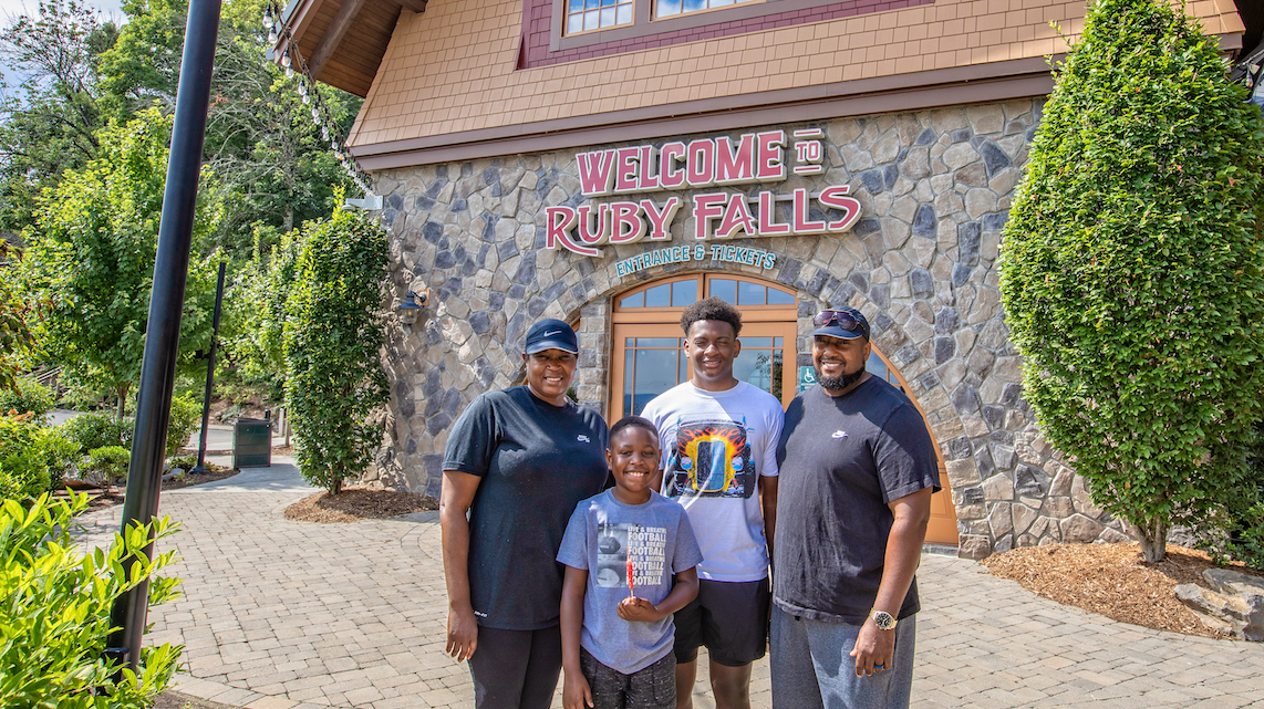 A mom and dad with two boys on the Village Plaza at Ruby Falls